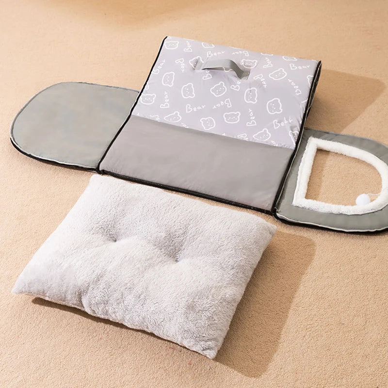 Grey dog bed house unzipped and laid flat into its panels, with the loose grey plush cushion in front