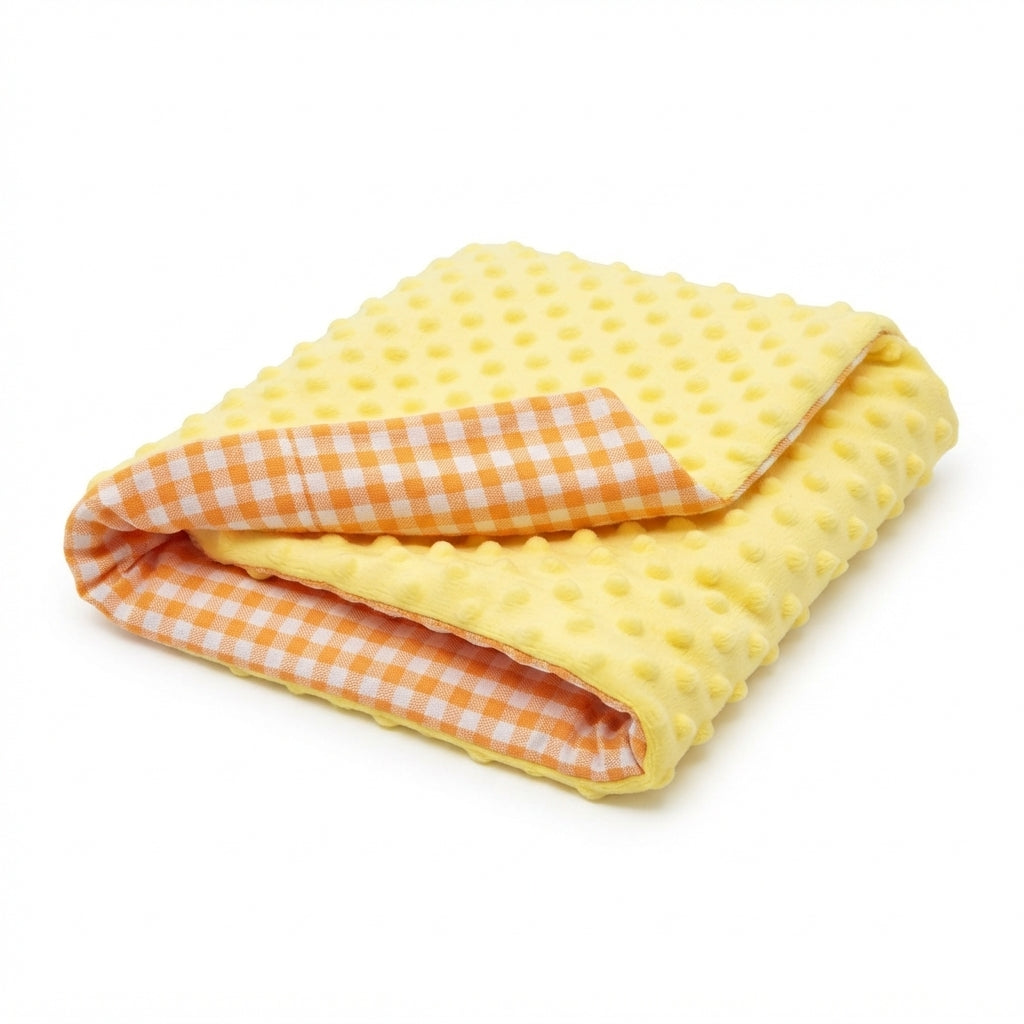Bed pads for dogs: a folded yellow pad in dotted plush, with orange and white gingham on the reverse side