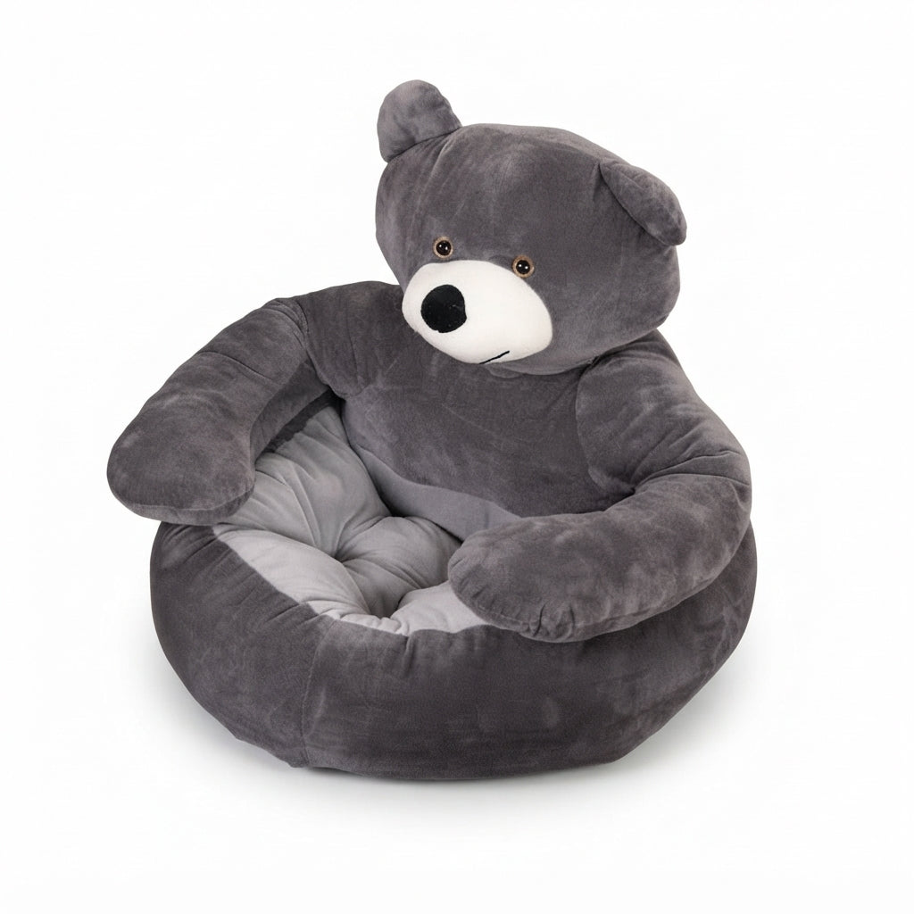 Grey teddy bear cat bed in short plush, the arms curved round a pale grey tufted cushion