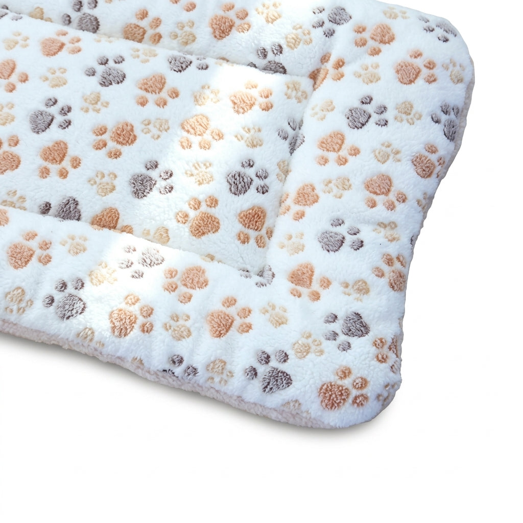 Padded fleece blanket bed in cream paws, white with tan, peach and grey paw prints, corner view