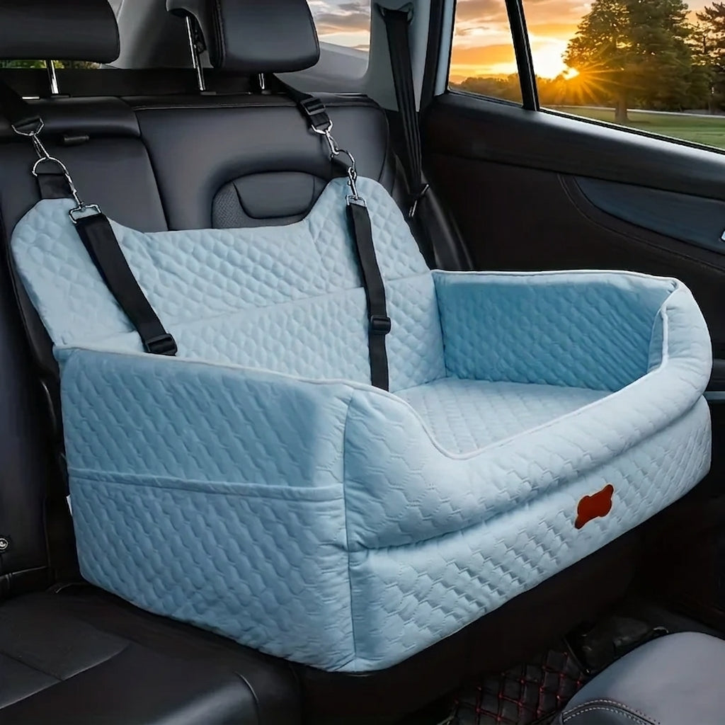 Blue quilted dog car booster seat, a pale sky blue, hooked to the headrests on the back seat of a car