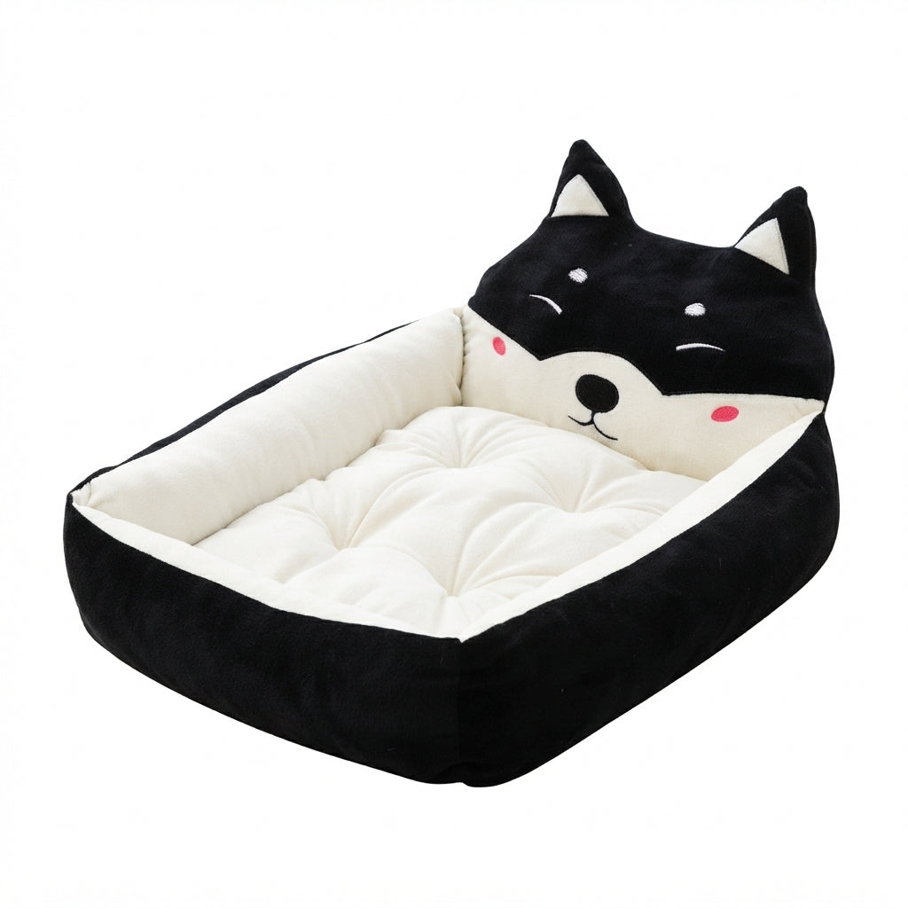 Cartoon pet bed with a black and white winking cat face headboard, black sides and a cream cushion