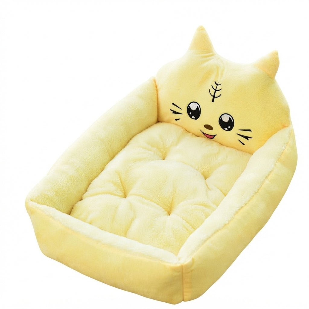 Cartoon pet bed in pale yellow with a smiling kitten face headboard with whiskers and a tufted cushion