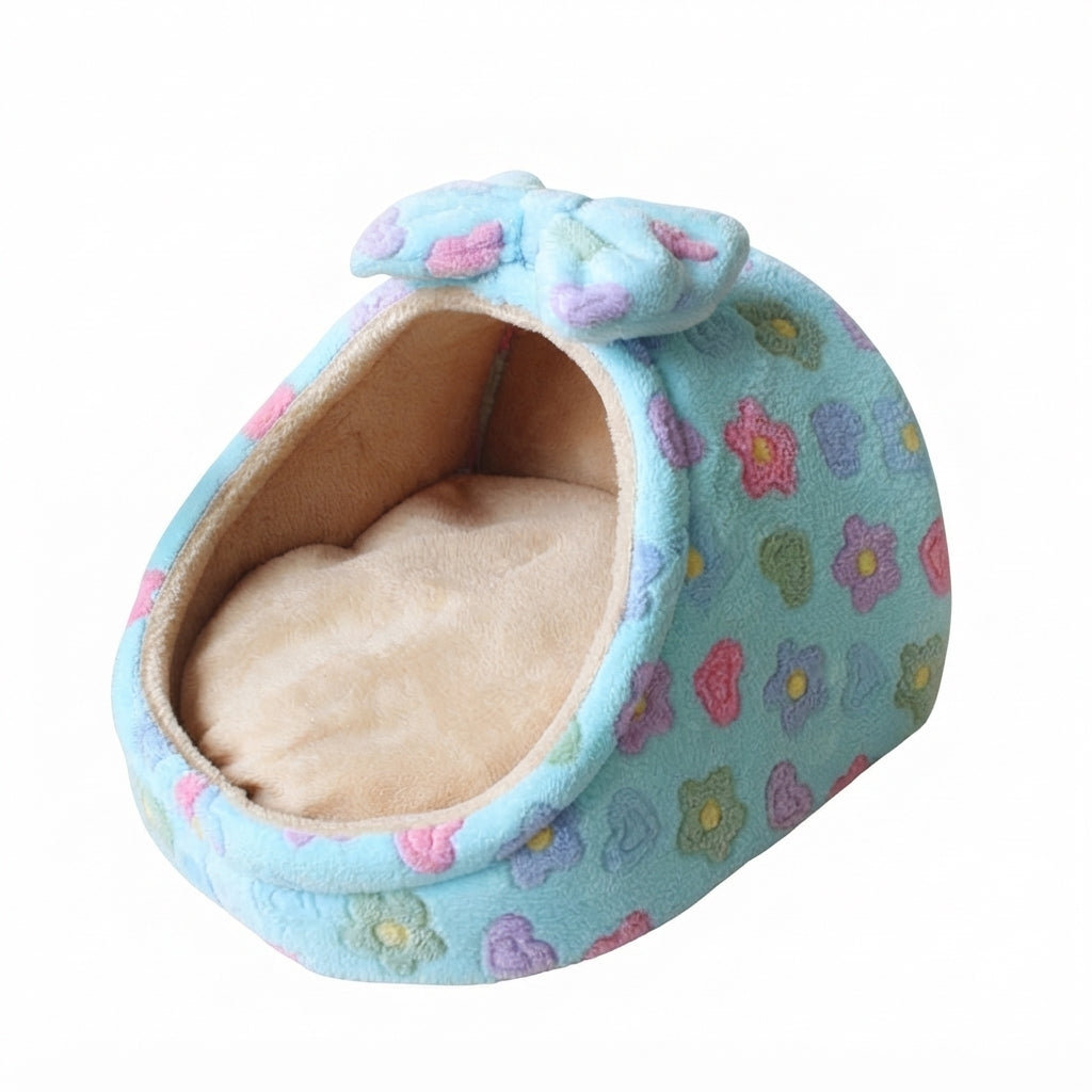 Covered cat bed with a bow in blue flowers: sky blue plush with pink, purple and green flowers, beige lining