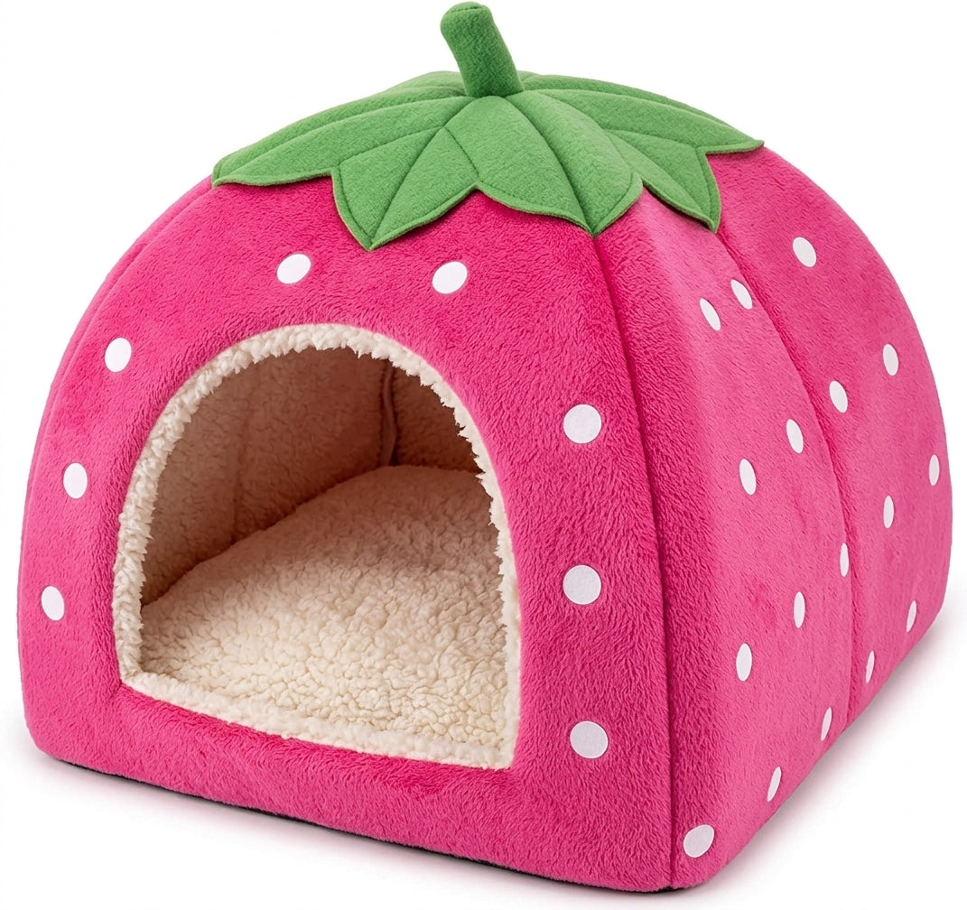 Pink strawberry cat cave bed with white dots, a green leaf and stalk on top and a cream fleece lining