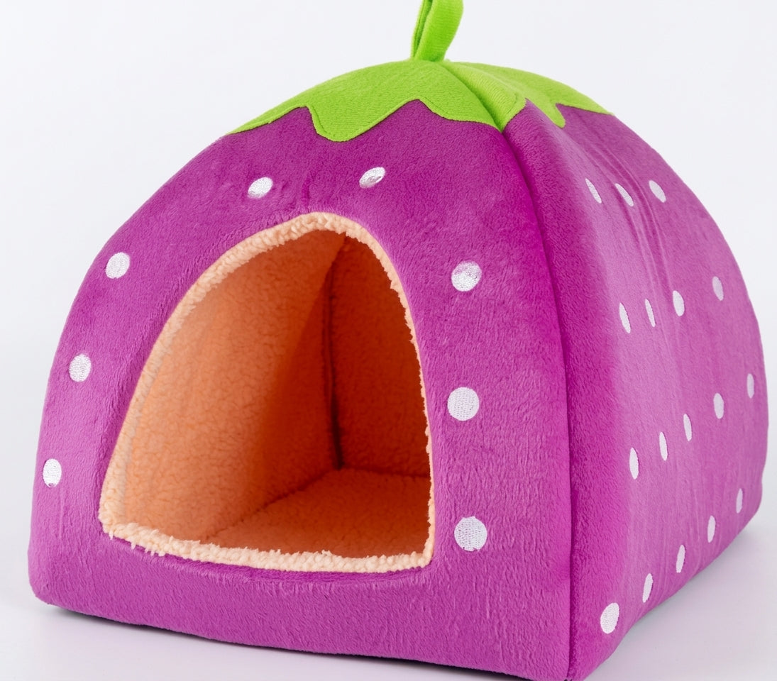 Purple strawberry cat cave bed with white dots, a green leaf top and a peach fleece lining inside