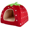 Cat cave bed shaped like a red strawberry with white dots, a green leaf top and a cream fleece lining