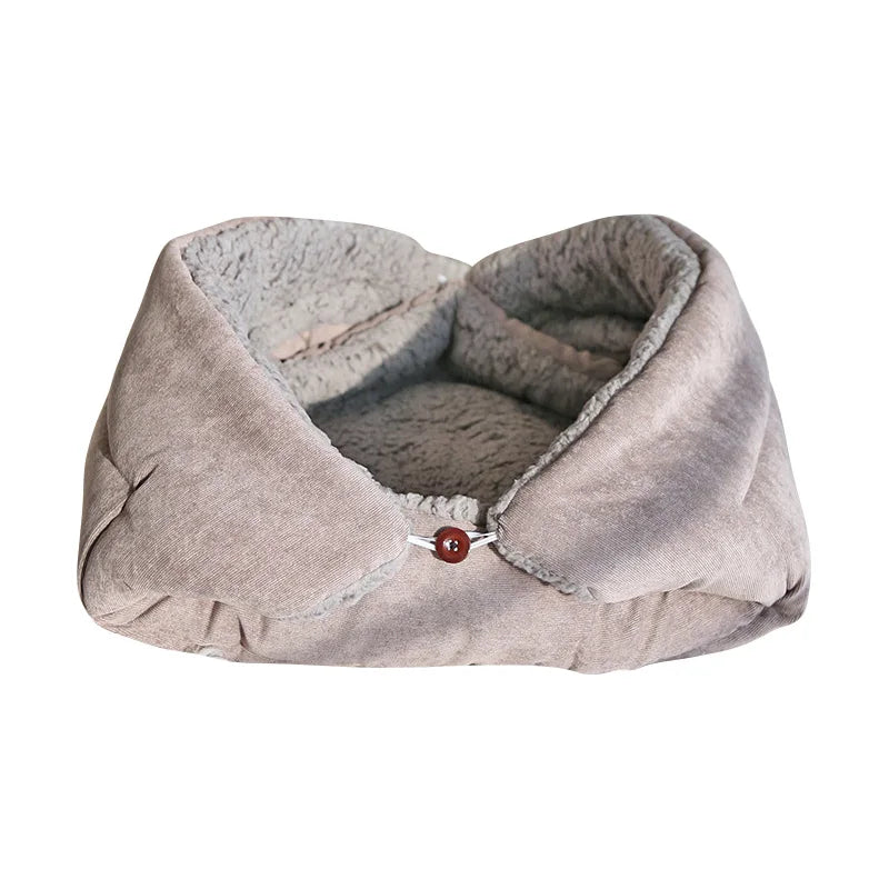 Cat cushion bed in light grey with a grey sherpa lining, sides folded up and fastened with a wooden button