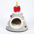 Christmas tree cat cave bed in Grey fleece with a red bow, a yellow pompom on top, white trim and a cream cushion inside