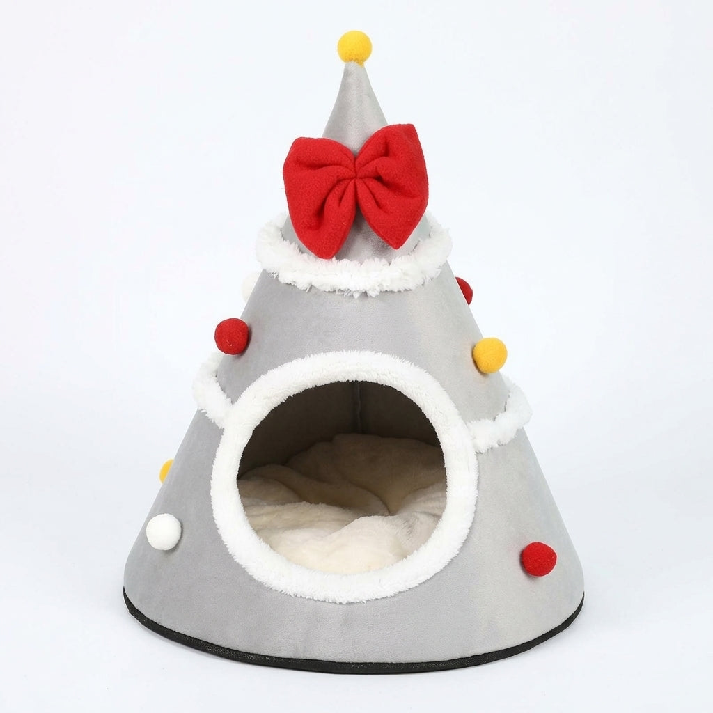 Christmas tree cat cave bed in Grey fleece with a red bow, a yellow pompom on top, white trim and a cream cushion inside