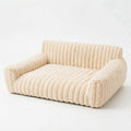 Corduroy couch bed for dogs in cream ribbed plush, with a low back and two rounded armrests
