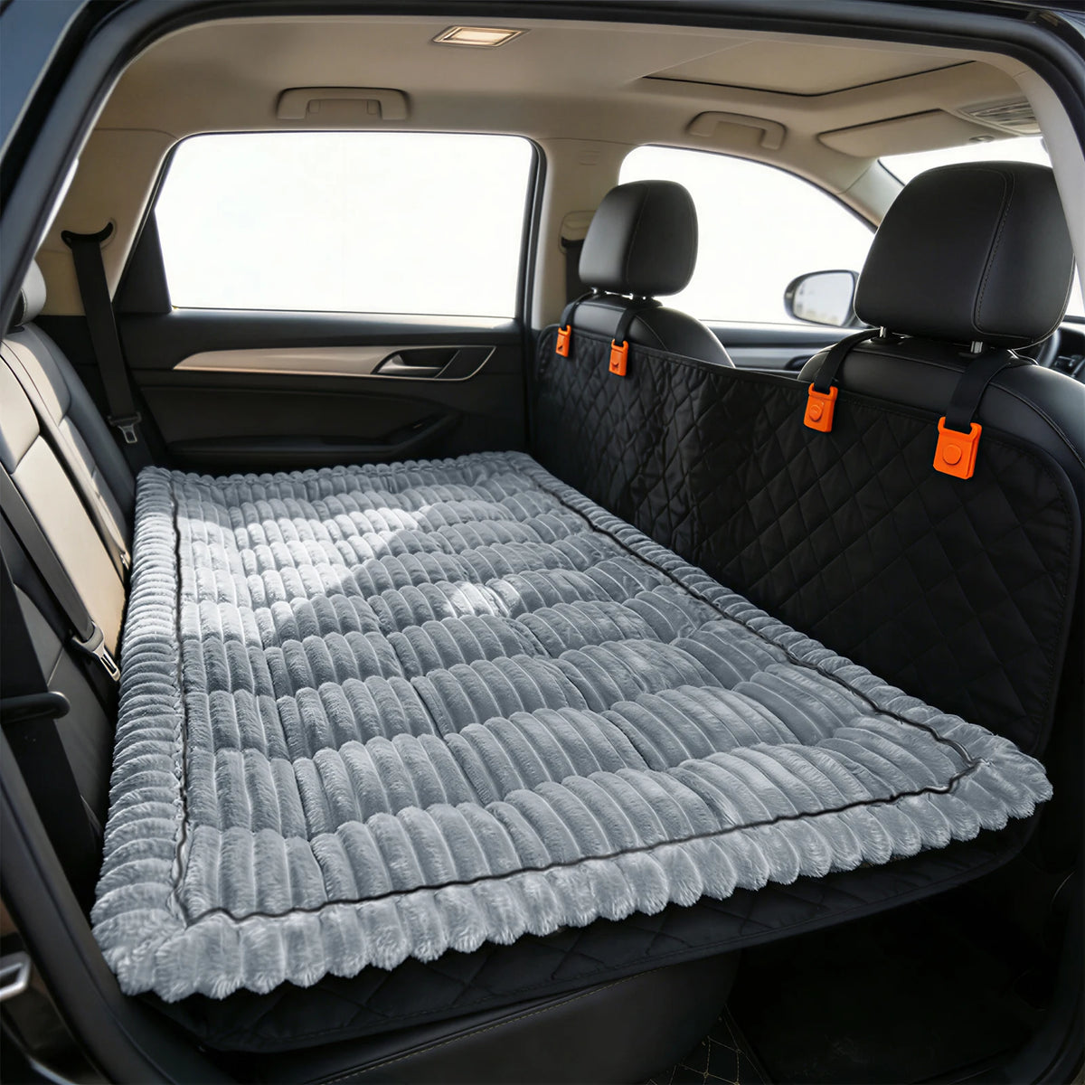 Corduroy pet mat in grey wide-rib plush, laid flat across a car's back seat in front of a black quilted seat cover