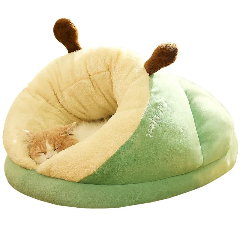 Cosy dog bed shaped like a green slipper with brown antlers, a ginger and white kitten asleep under the cream hood