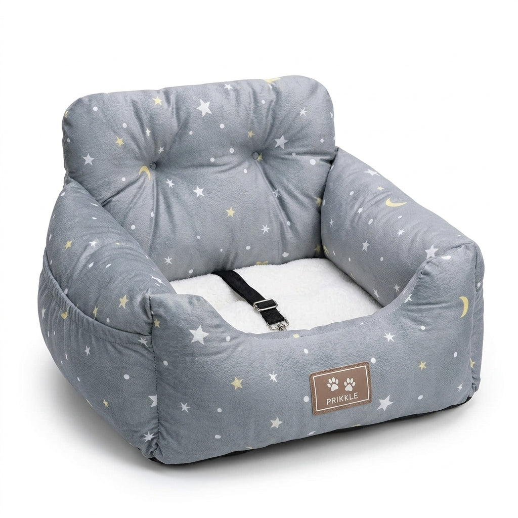 Dog travel bed in grey star print with yellow moons, a white fleece cushion and a short safety strap with clip