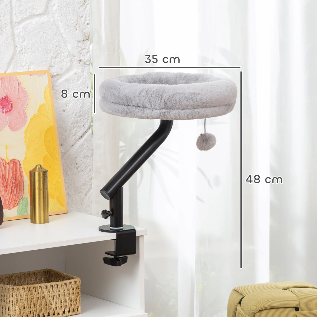 Dimensions of the desk clamp cat bed: 35 cm across, 8 cm deep and 48 cm high on its black arm, clamped to a shelf