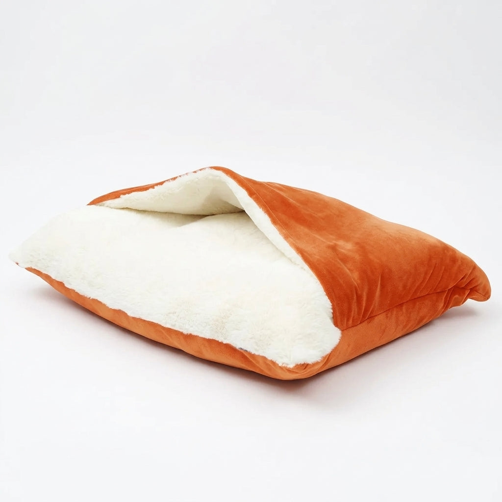 Dog bed cave in orange plush velvet, the top flap lifted to show the cream sherpa lining inside