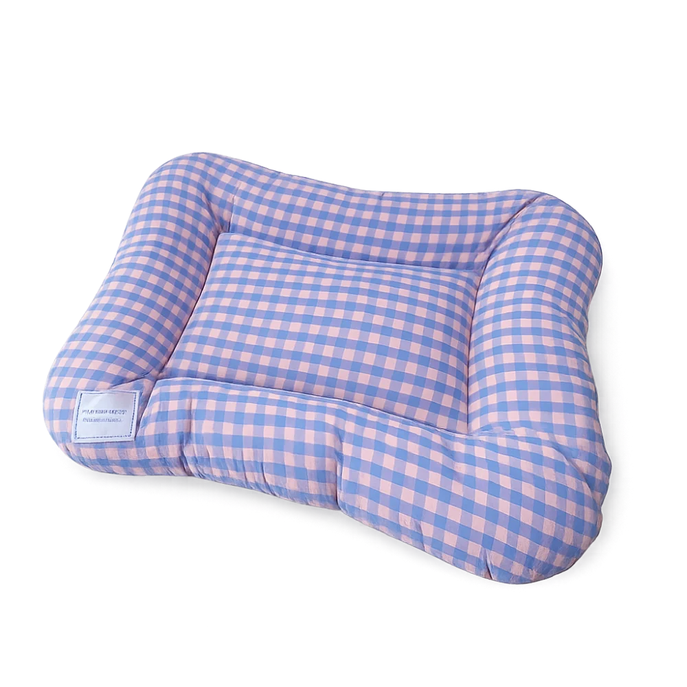 Dog bed cushion in lilac and pink gingham with a raised padded rim and a small white label, on a black background
