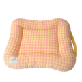 Dog bed cushion in peach and yellow gingham, a padded rectangle with a raised rim and a yellow carry strap