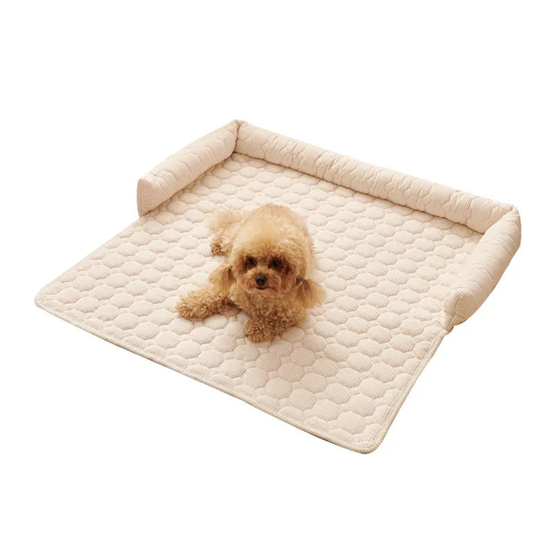 Dog bed for sofa in beige quilted fabric, a square pad with bolsters on three sides and a small apricot poodle lying on it