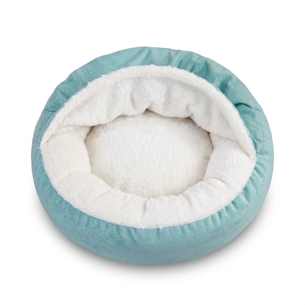Dog bed with hood in aqua velvet, a round cuddler seen from above with a white plush lining and raised hood