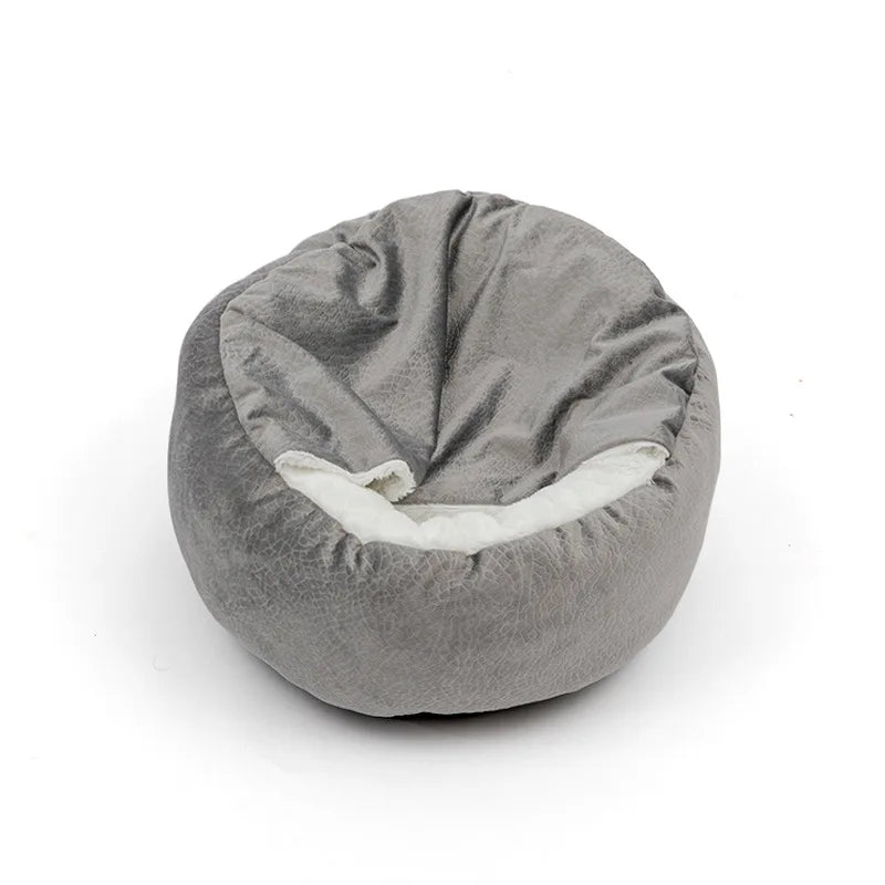 Round grey hooded bed with a crackle-textured velvet cover and the blanket hood folded over a white lining
