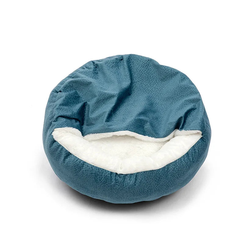 Round petrol blue hooded bed with a textured velvet cover, the hood lifted to show the white plush inside