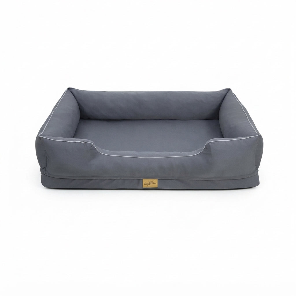 Dog bed XL in grey fabric with raised bolsters on three sides, a lower front edge and pale piping