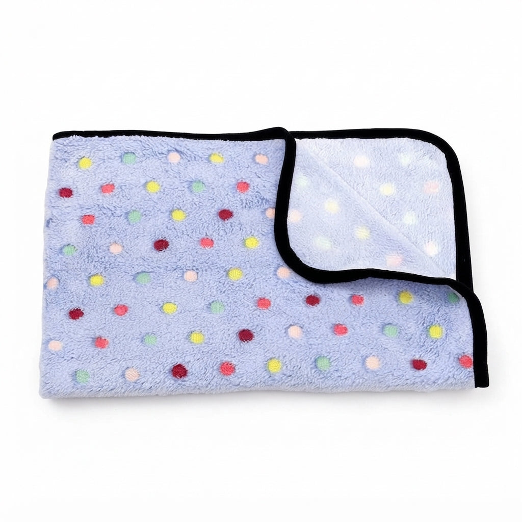 Folded lavender blue coral fleece blanket with small multicoloured dots and a black bound edge