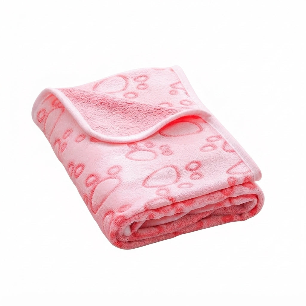 Folded pale pink fleece blanket with embossed outline paw prints and a pink bound edge