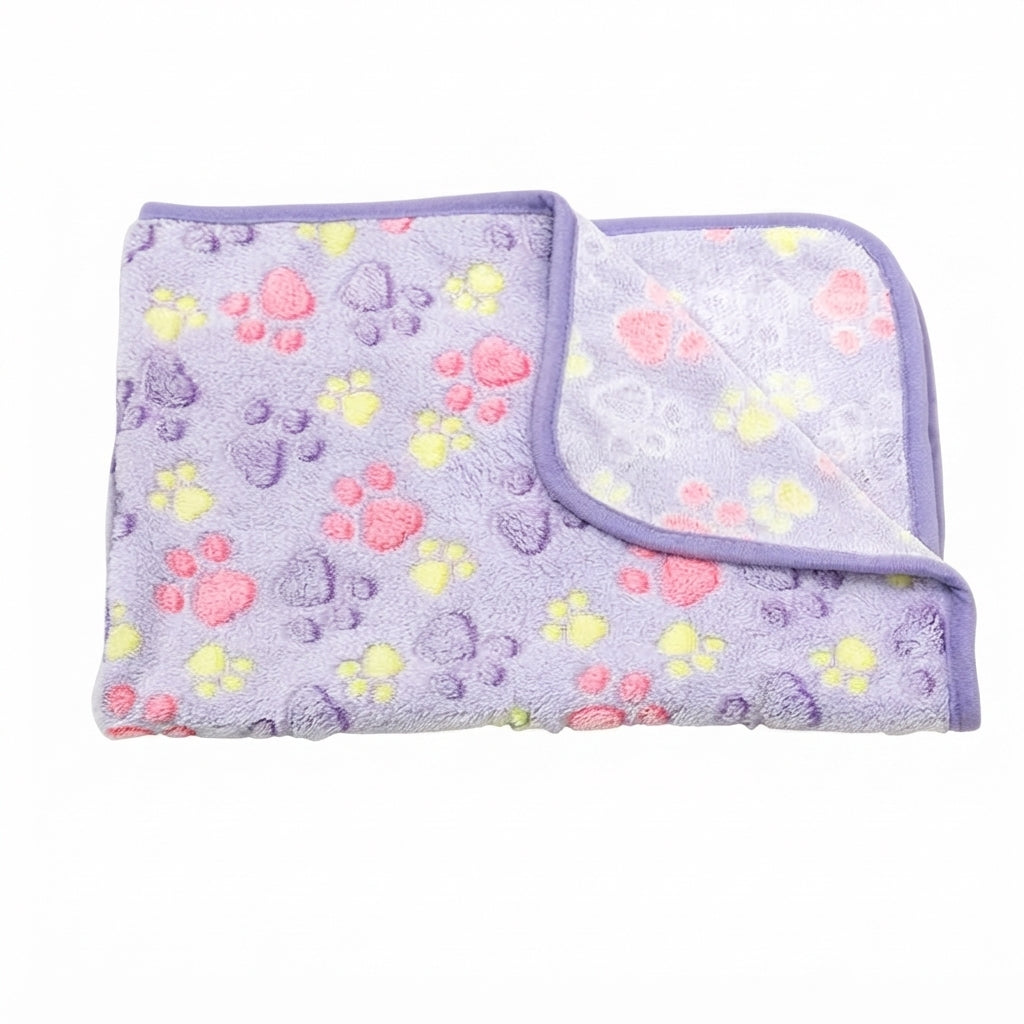 Folded lilac coral fleece blanket with purple, pink and yellow paw prints and a purple edge