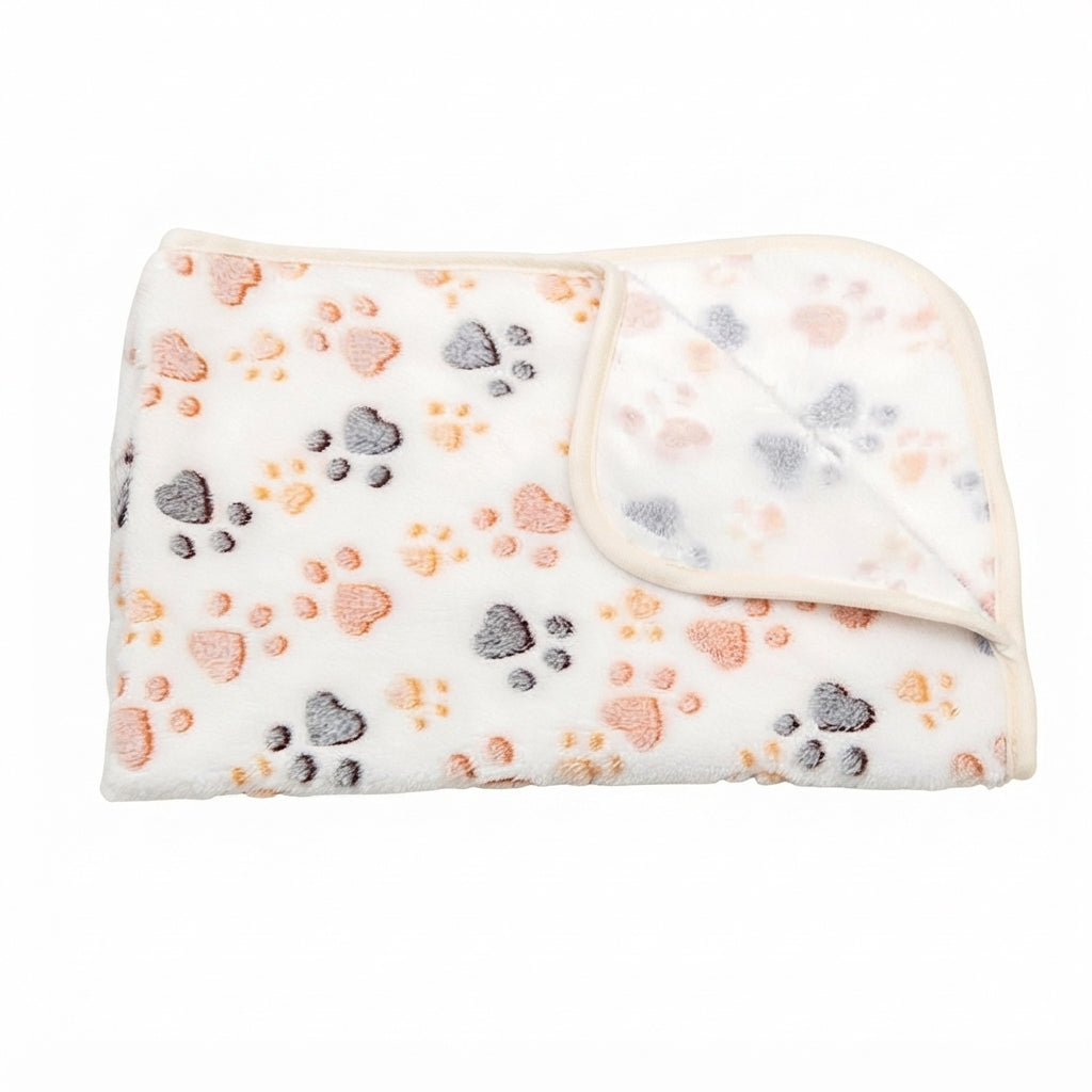 Folded white coral fleece blanket with peach, orange and grey paw prints and a cream edge