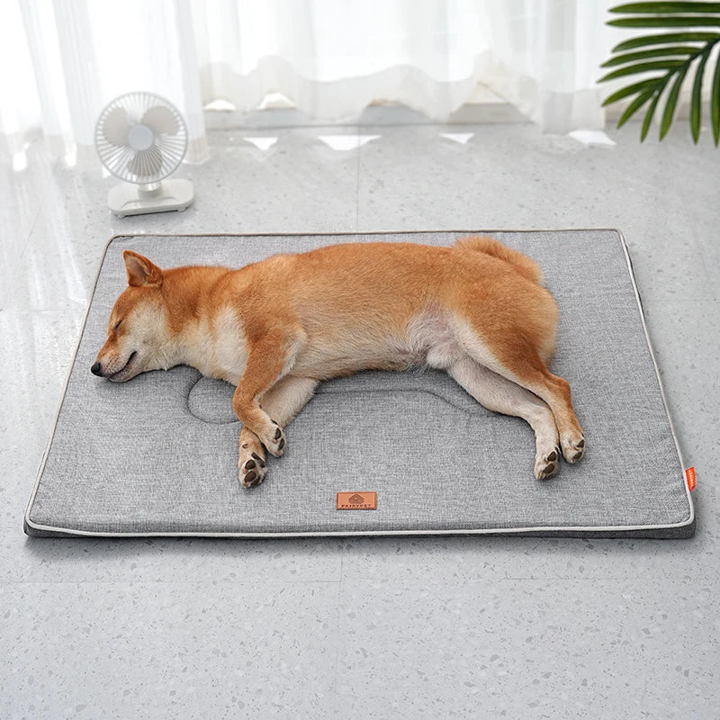 Shiba Inu asleep on its side on the light grey linen mat, laid on a speckled floor near a small fan