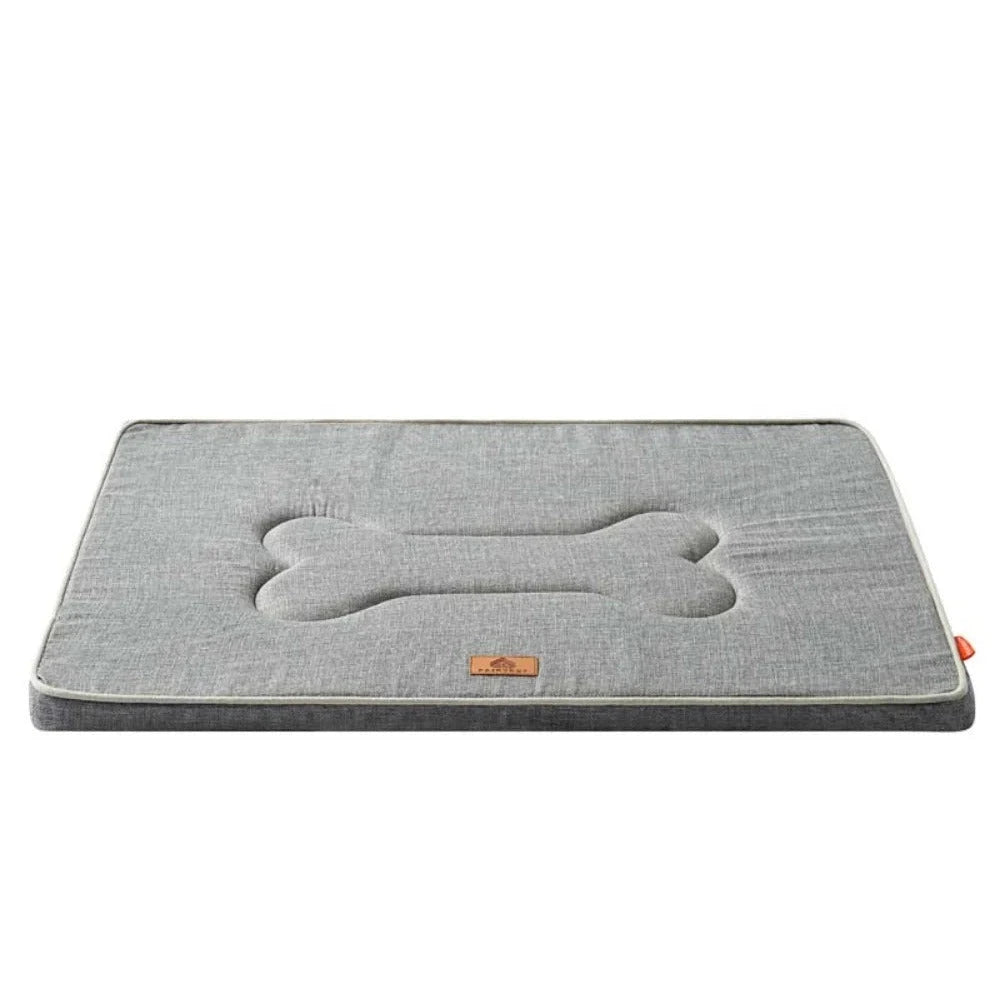 Dog cage bed mat in light grey linen, a flat padded rectangle with a quilted bone shape in the centre