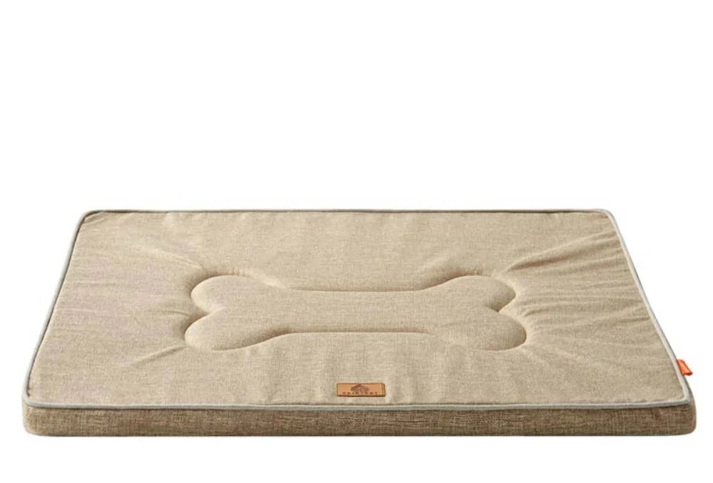 Dog cage bed mat in tea brown linen: a pale beige top with a quilted bone shape and darker brown sides