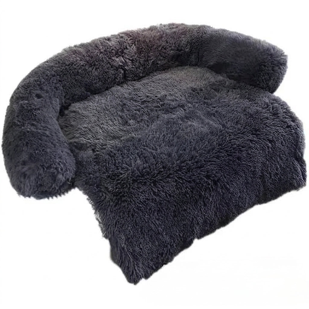 Dog couch bed in black shaggy plush, with a padded bolster on three sides and a long front flap