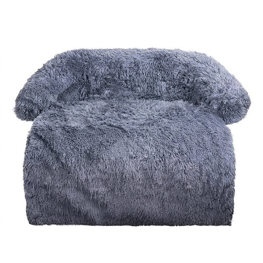 Dog couch bed in dark grey shaggy plush with a slight blue tone, a padded bolster round the back and sides