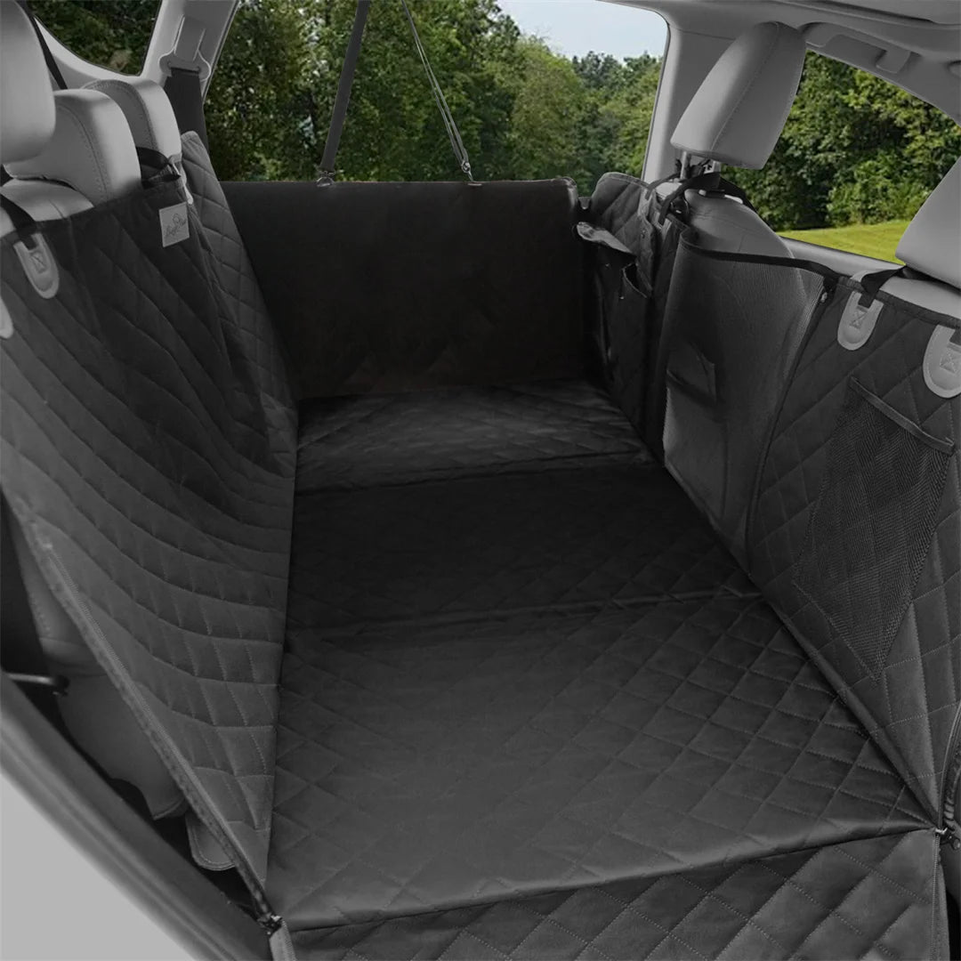 Black quilted dog hammock fitted across the back seat of a car, with side flaps covering the doors