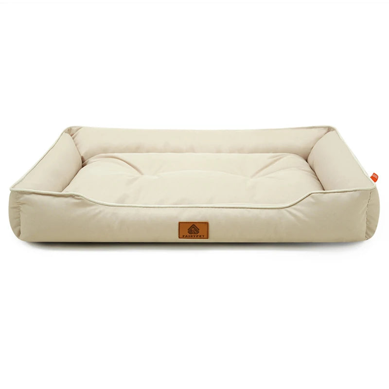 Dog settee bed in cream with matching piping, raised bolster sides and a padded, tufted base