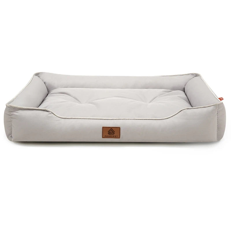 Dog settee bed in light grey fabric, a rectangular bed with raised bolster sides, piped edges and a tufted base