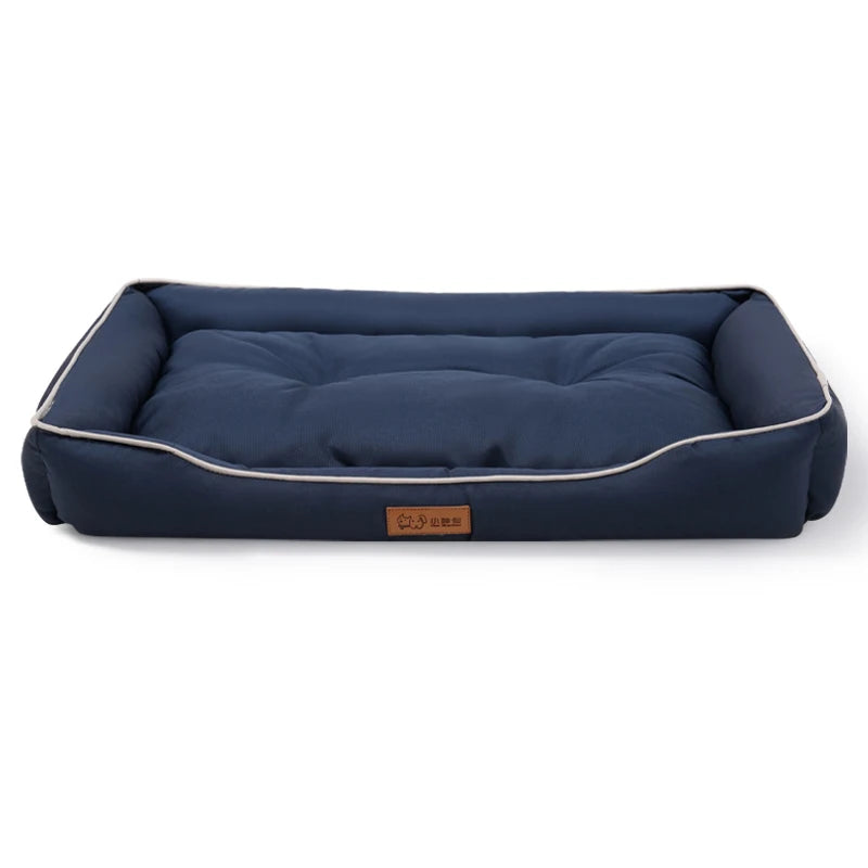 Dog settee bed in navy with pale piping on the bolster sides and a padded, tufted base