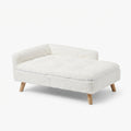 Dog sofa bed shaped like a chaise longue, in white faux fur with a padded seat and four wooden legs