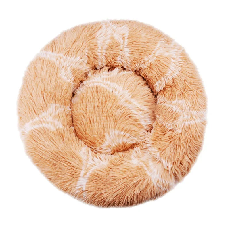 Round donut dog bed in caramel swirl plush, light orange-brown with pale wavy lines, seen from above
