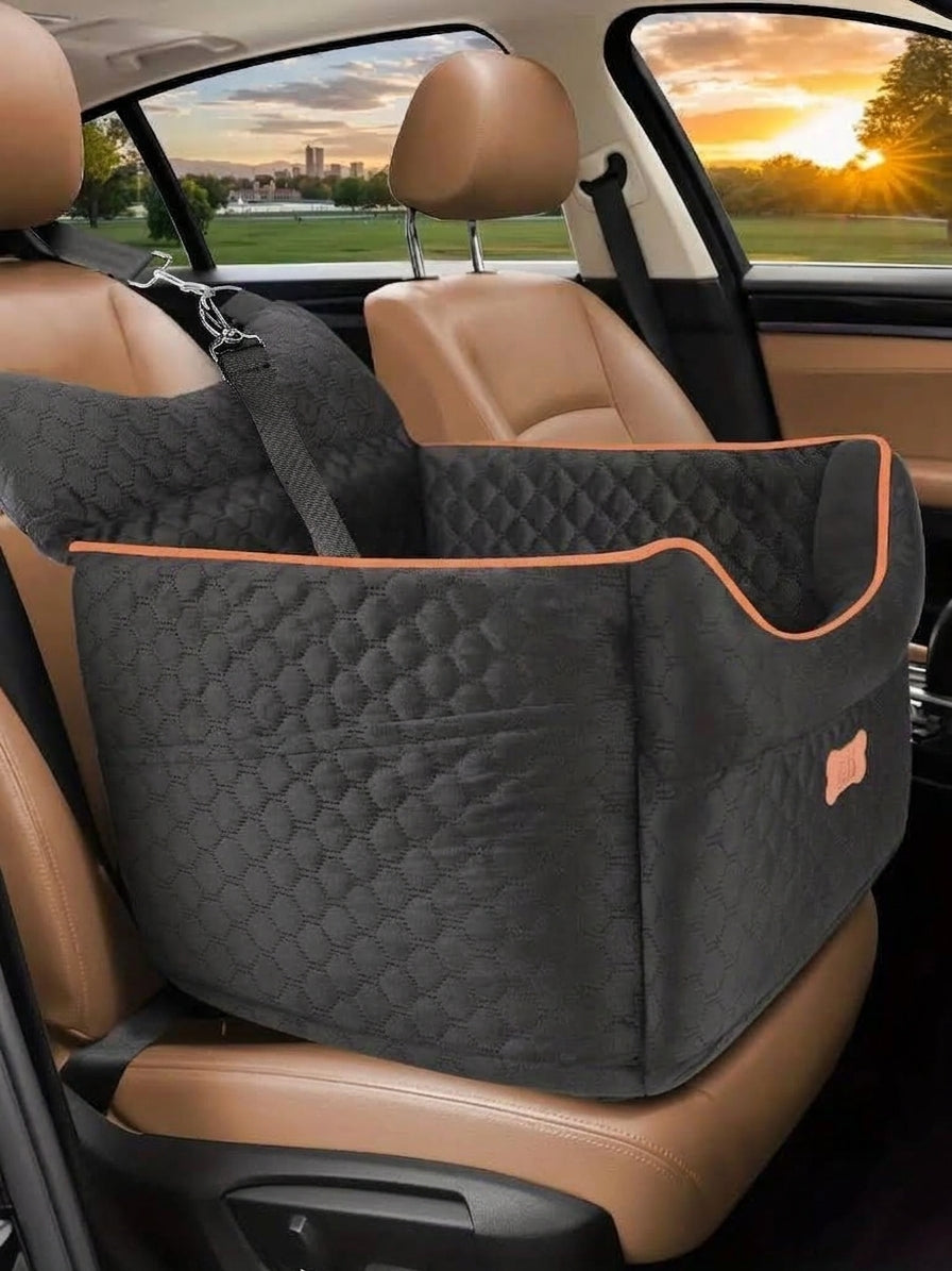 Elevated car bed for dog travel in black quilted fabric with orange piping, strapped to a tan leather front seat