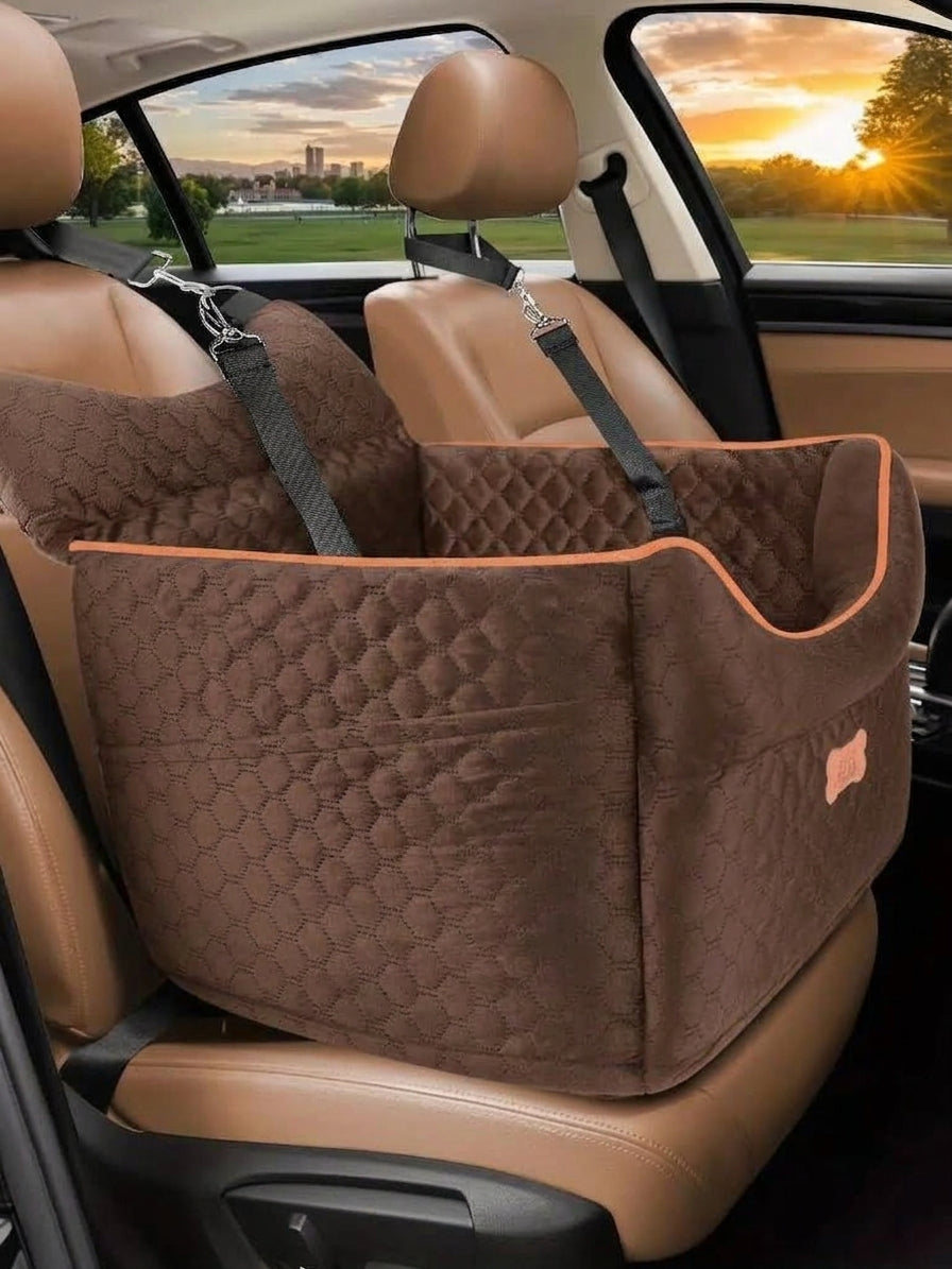 Elevated car bed in tea brown quilted fabric with orange piping, clipped to the headrest of a tan leather front seat