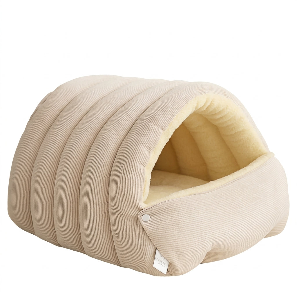 Enclosed dog bed in beige ribbed corduroy with a pale yellow fleece lining and a front flap held by snap buttons