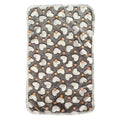 Grey fleece blanket for dog beds laid flat, printed with white hearts and small orange dots, with a pale edge