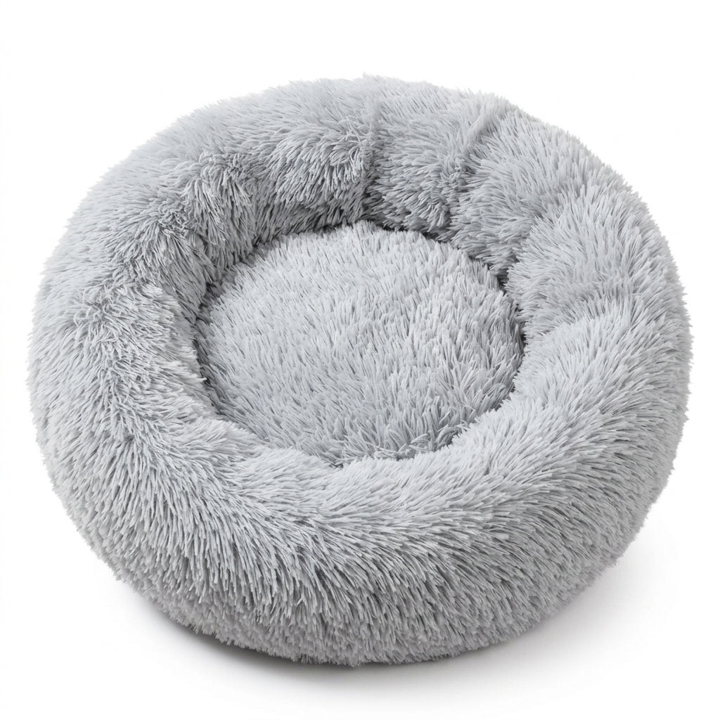 Round fluffy cat bed in light grey shaggy faux fur with a thick raised rim and a soft centre