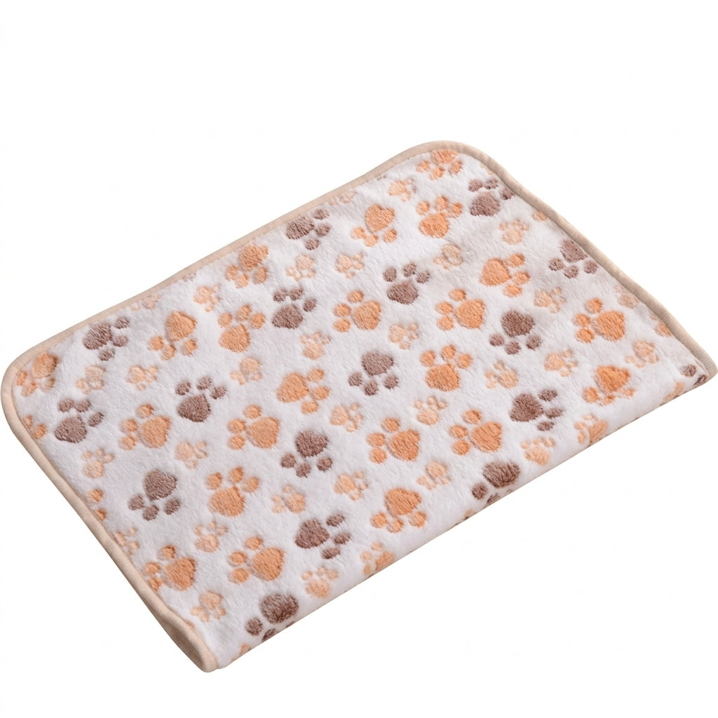 Fluffy cat bedding in beige coral fleece, a pale cream blanket with orange and brown paw prints and a beige edge