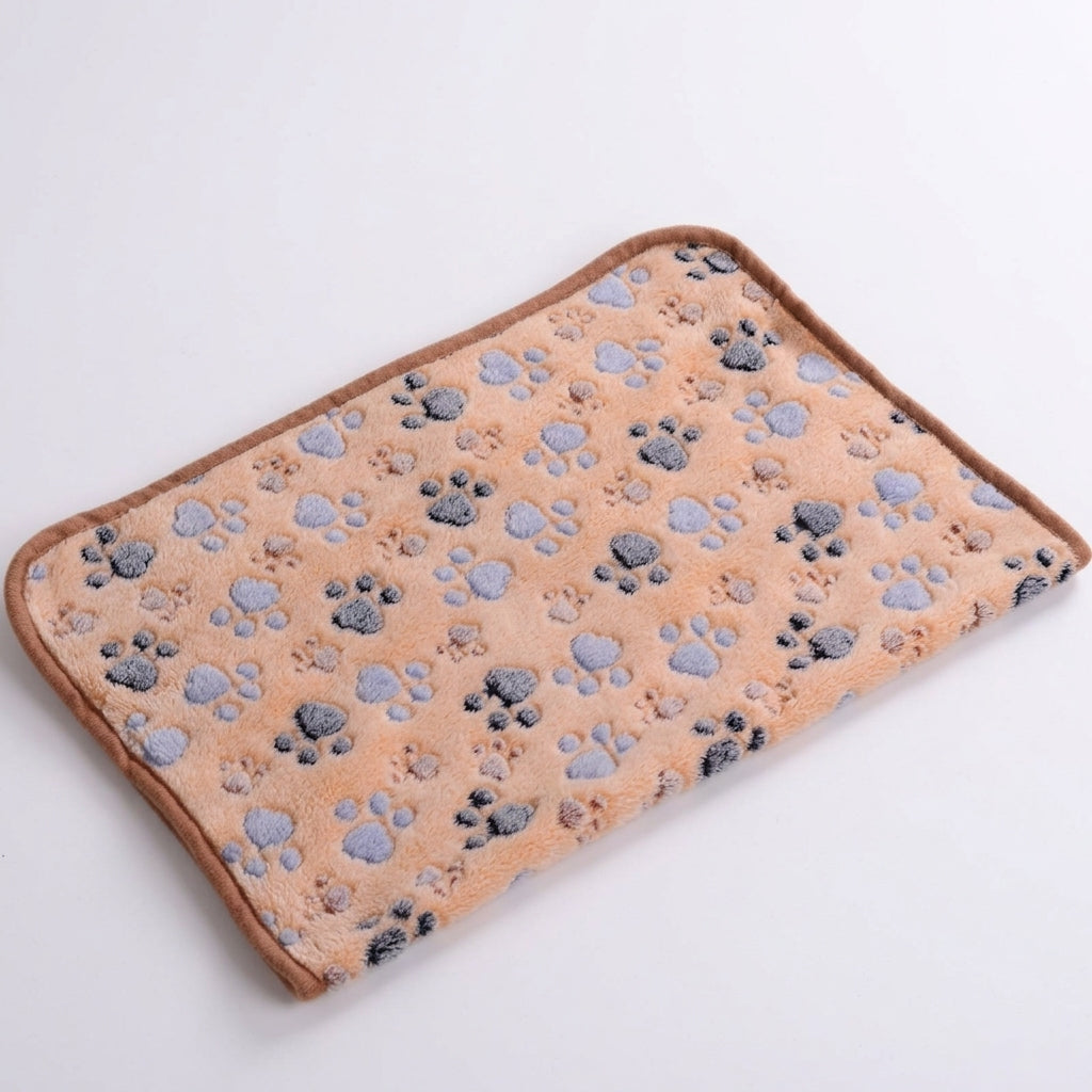 Coral fleece blanket in coffee, a light tan with grey and lilac paw prints and a brown bound edge