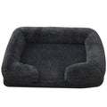 Fluffy dog bed in charcoal shaggy plush with bolsters round the back and sides and a flat padded base
